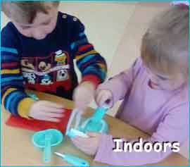 Children playing at table with words indoors