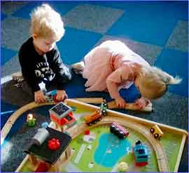 Girl and boy with train set