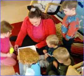 Teacher reading a story to kids